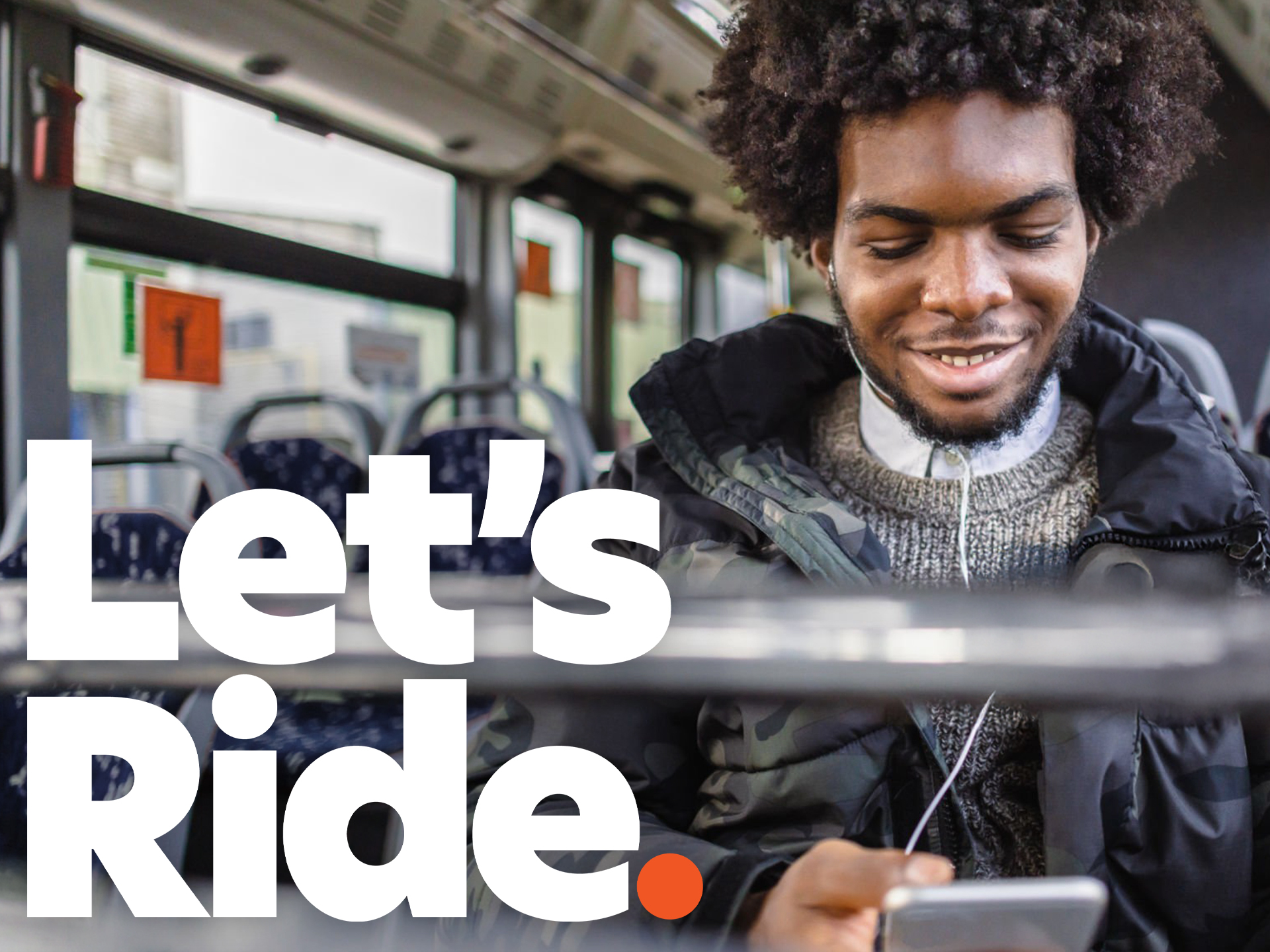 man sitting on bus with headphones holding an iPad. Text says let's ride.
